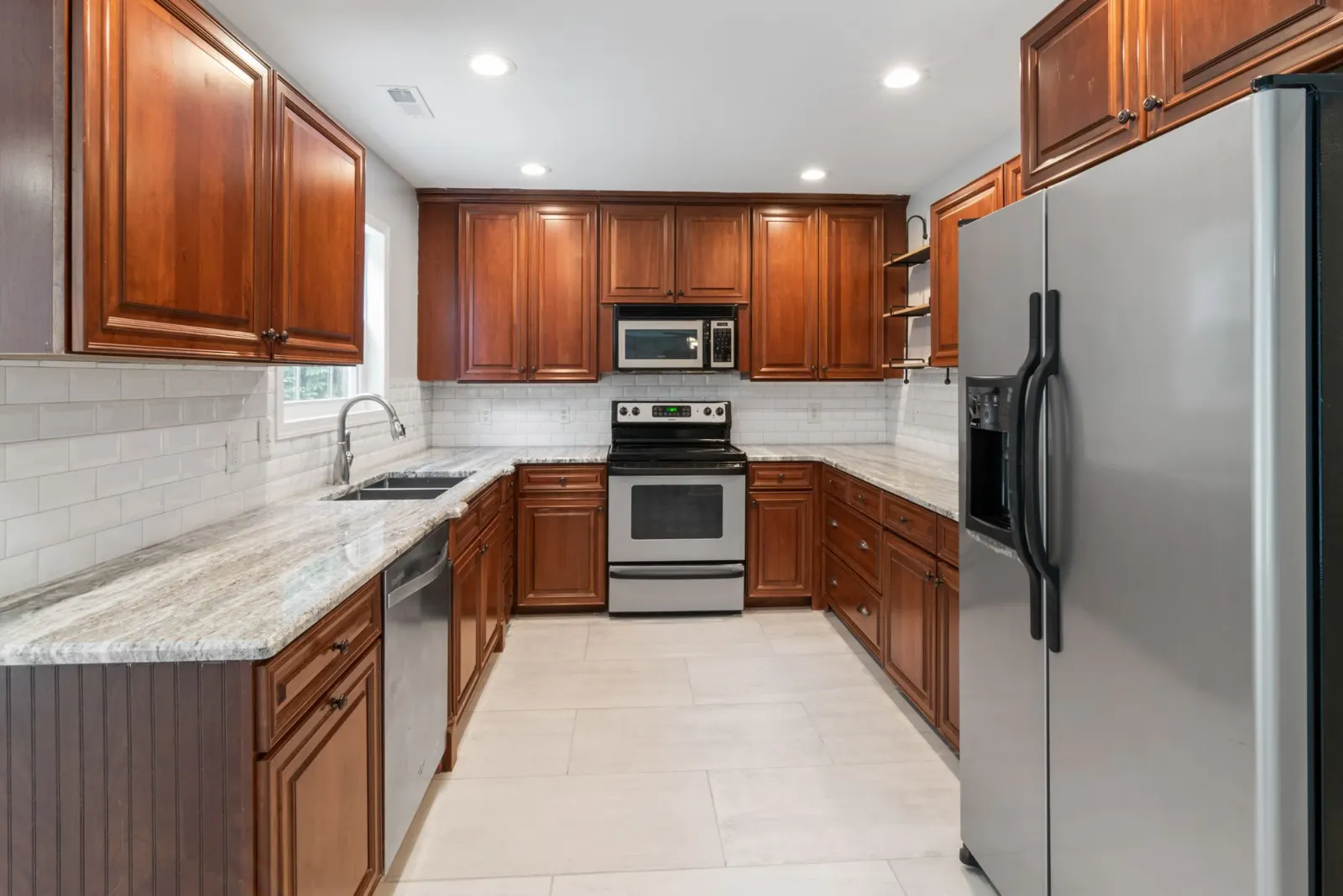 Kitchen with wood cabinets and stone countertops