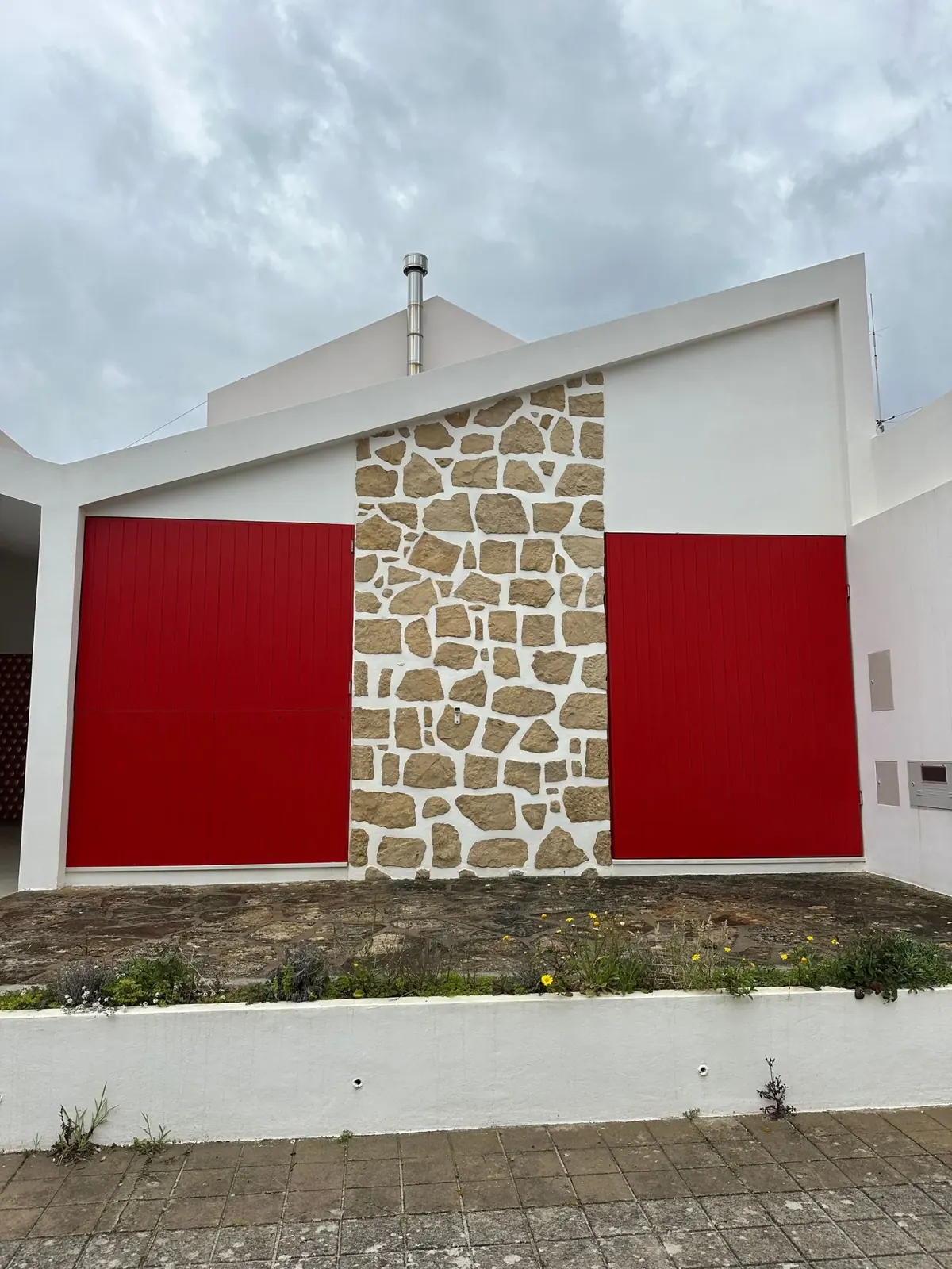 Modern house facade with a natural stone feature wall